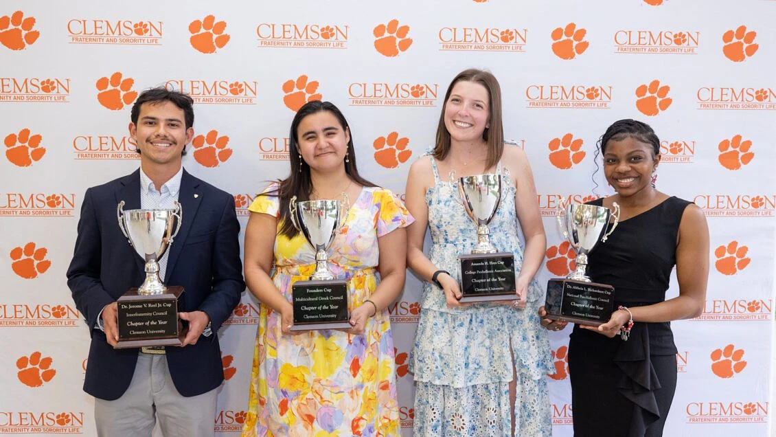 Students from the 2023-24 Fraternity and Sorority Life Chapters of the Year pose with their organization's awards.