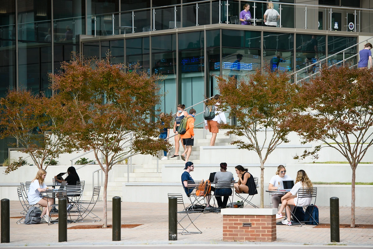 Students enjoy a sunny spring day in front of the College of Business building